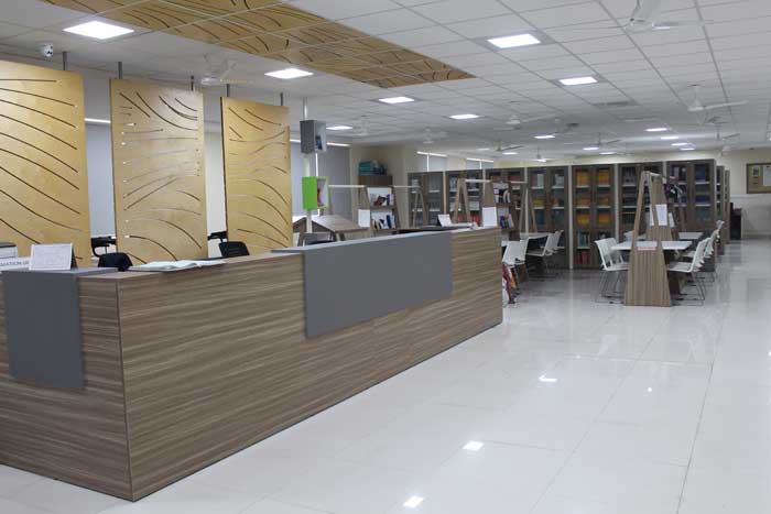 Library interior with study desks and shelves of books